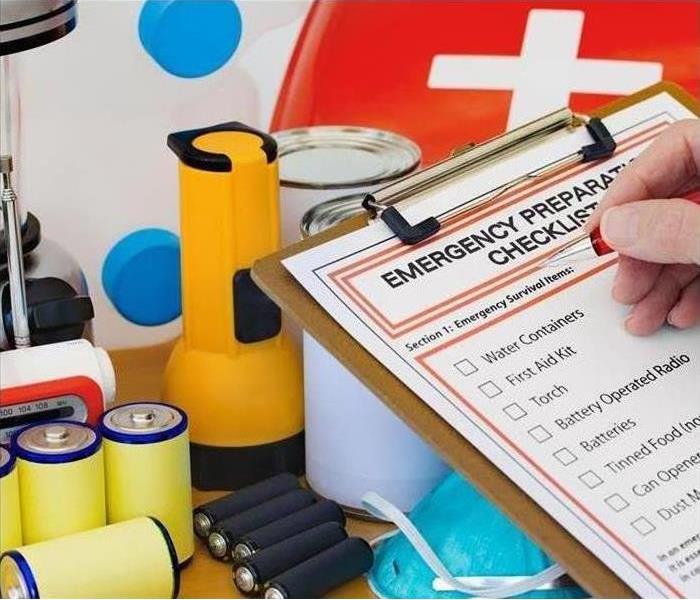 Emergency kit and a person with a checklist