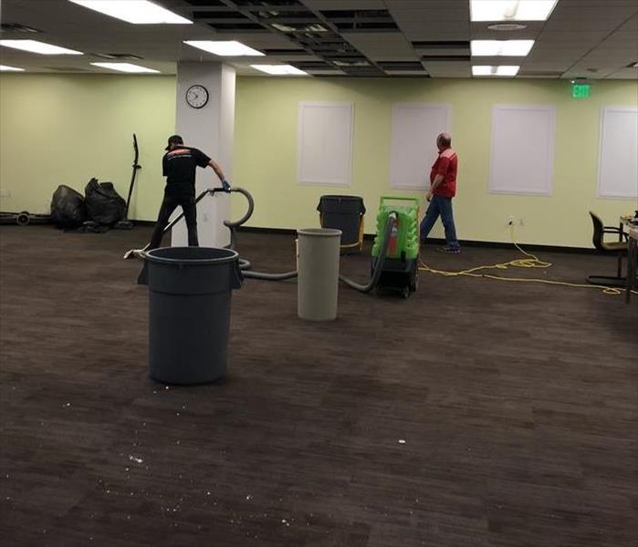 SERVPRO professional clean up carpet with proper equipment after suffering water damage in commercial bulding. 